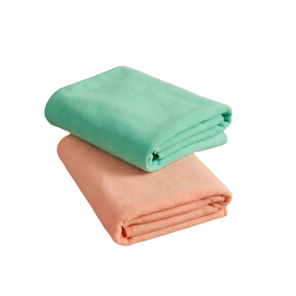 Two folded towels, one green and one peach, on a white background